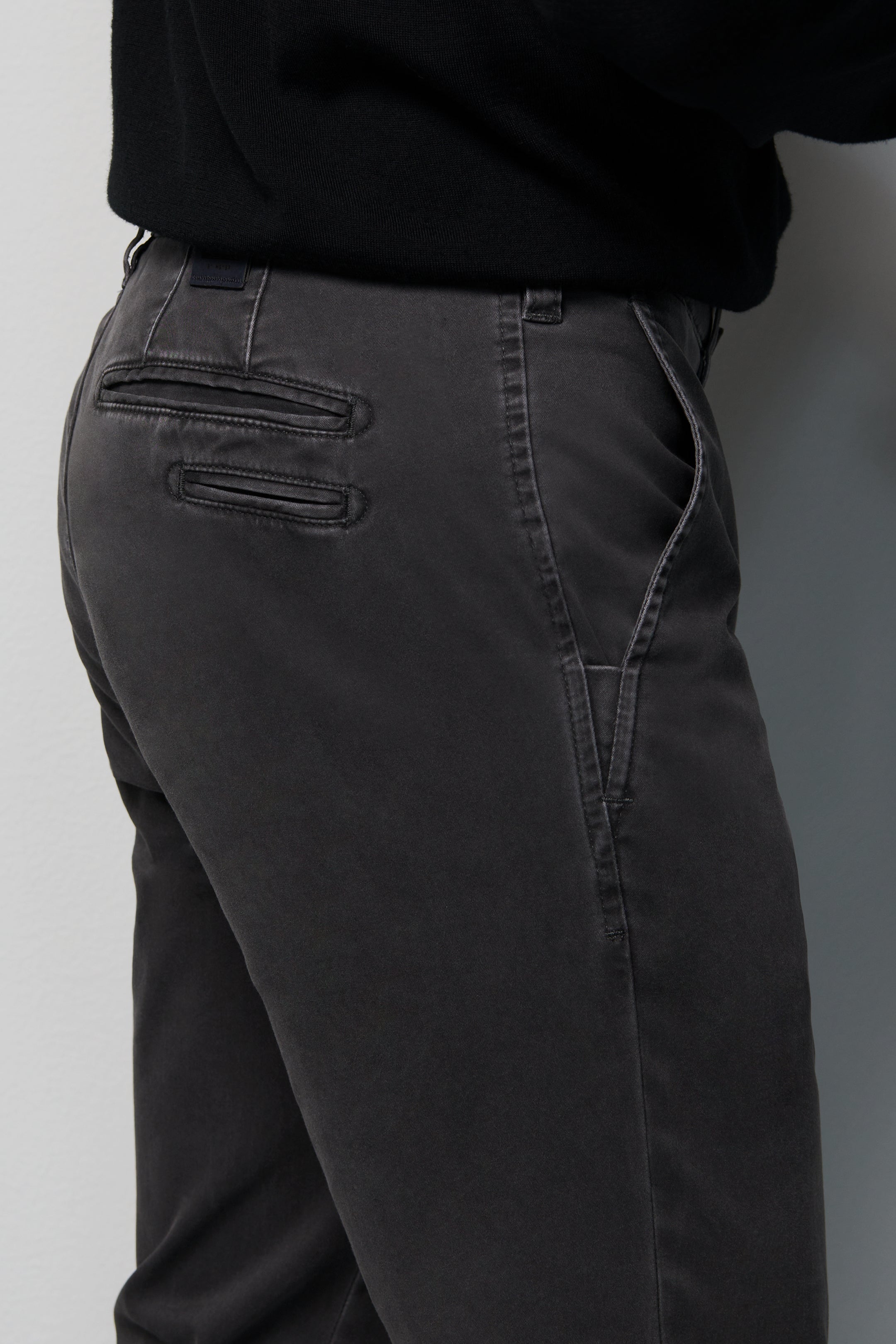 Dark gray pants with a plain background